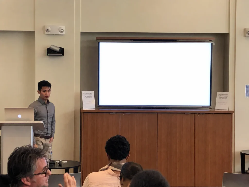 Xien Chua presenting at the UCSF P01 meeting: big ideas, big screen.